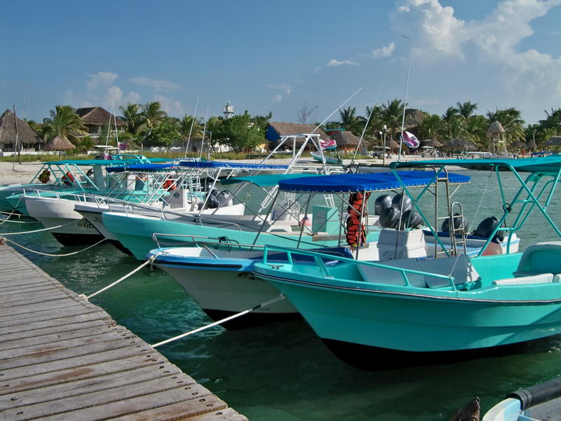 Pier at Holbox Island Gulf coast. boats for fishing or snorkeling
